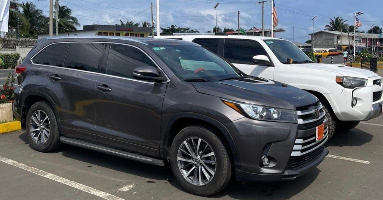 ITS Toyota Highlander and 4Runner parked in daylight outside the ITS yard in Monrovia